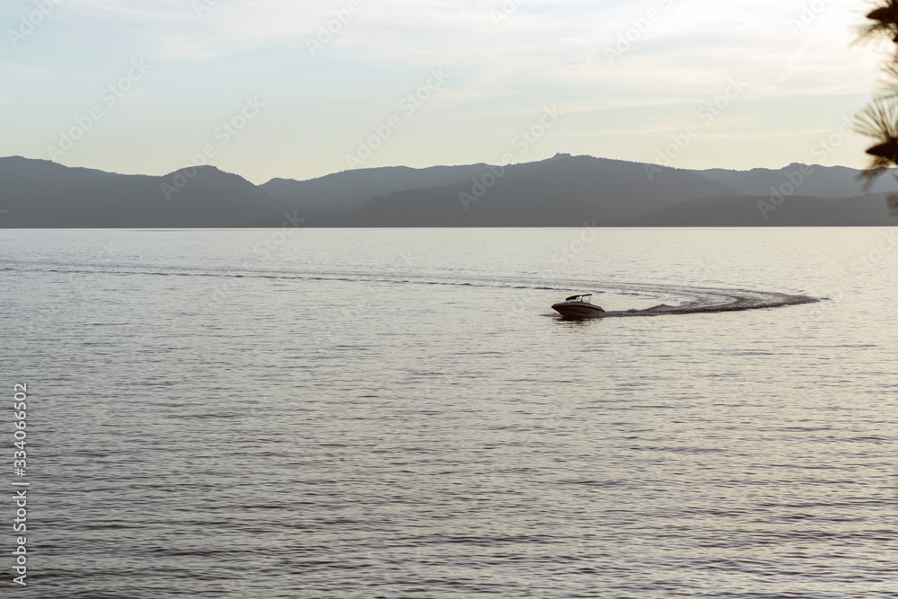 Speed boat making waves at sunset in Lake Tahoe Speed boat making waves at sunset in Lake Tahoe