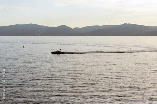 Speed boat making waves at sunset in Lake Tahoe