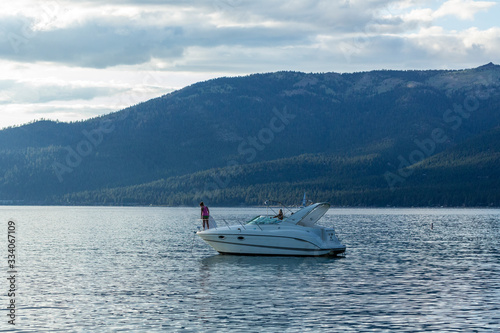 Boats anchored near a beach at sunset in lake tahoe © ecummings00