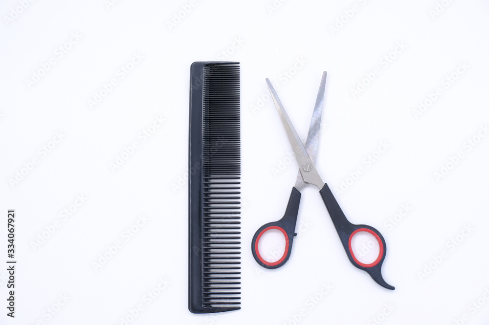 Black comb and scissors isolated on white background Black comb and scissors isolated on white background