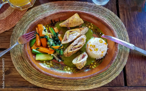 Delicious chicken stuffed with cheese accompanied by steamed vegetables and rice