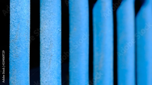 Abstract macro photography. Close up blue line pattern of steel fence