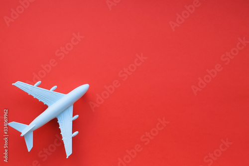 Model airplane on a red background. Space for text. Travel concept.