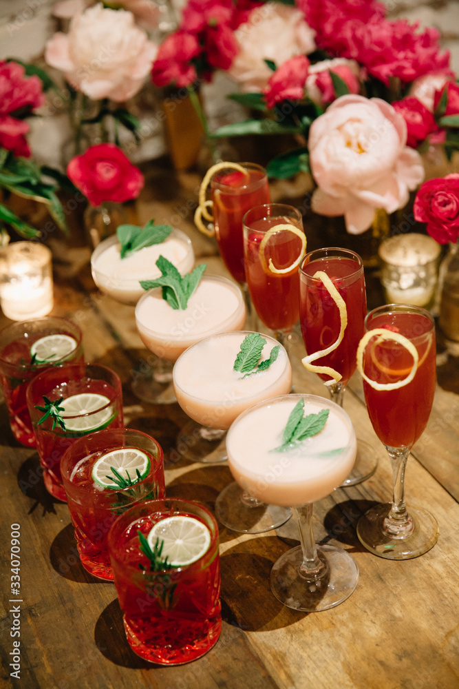 An array of pink-colored alcoholic drinks ready to be served