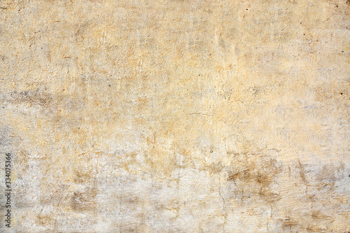 Old stucco wall texture of yellow and beige color