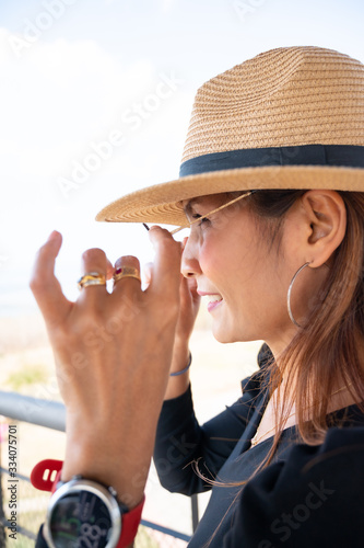 Asian woman with sunglasses on tower photo