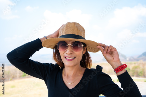 Asian woman with sunglasses on tower photo