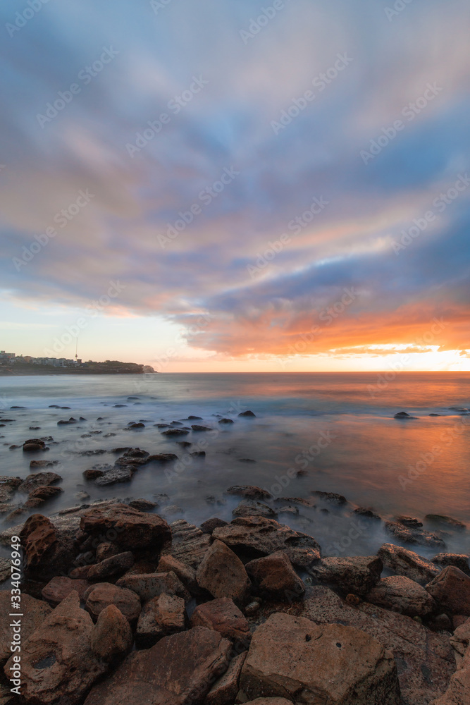 Long exposure view of Bronte Beach, Sydney with sunrise sky.