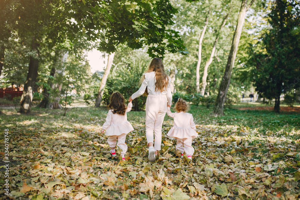 Children in a summer park. Sisters playing. Kids in a pink clothes. Children in a summer park. Sisters playing. Kids in a pink clothes.
