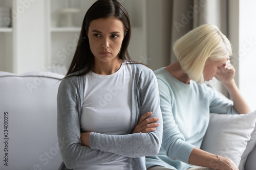 Billede på lærred Offended millennial girl sit separately avoid talking with mature mother after f