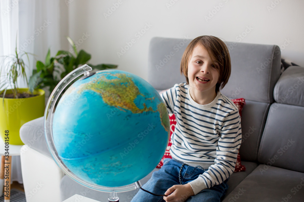 Little child, looking at illuminated globe, exploring Little child, looking at illuminated globe, exploring