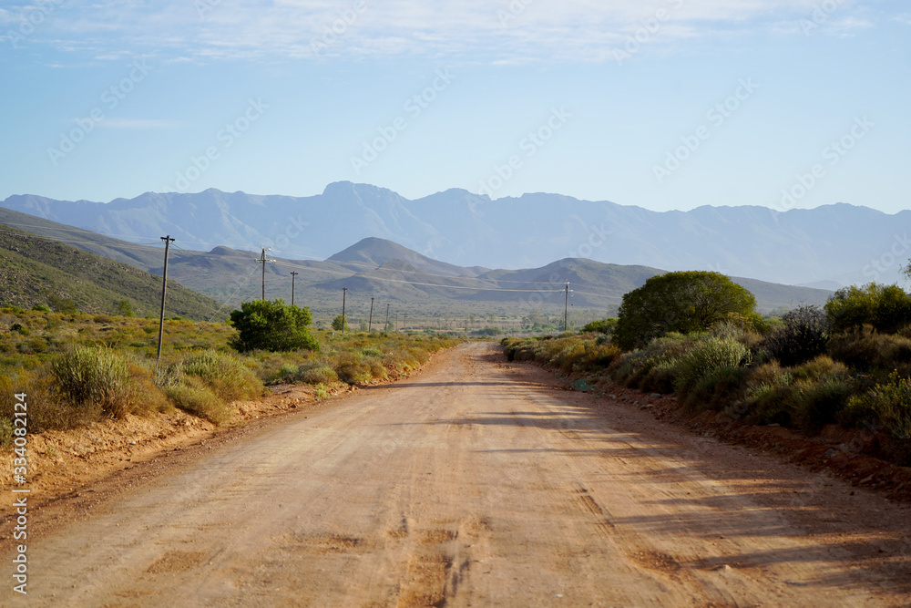 Long open dirt road in mountain landscape Long open dirt road in mountain landscape