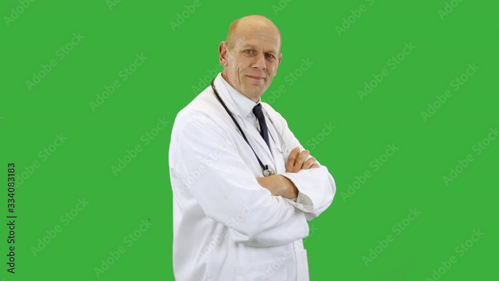A happy smiling doctor wearing a scientist white lab coat turns, folding arms and smiles. The man is wearing a shirt and tie with stethoscope. A happy smiling doctor wearing a scientist white lab coat turns, folding arms and smiles. The man is wearing a shirt and tie with stethoscope.