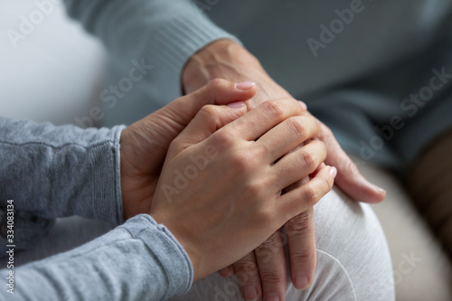 Close up of supportive grown-up daughter hug elderly mom hand talk share close intimate moment together, loving adult girl child comfort mature mother show care and support, family unity concept