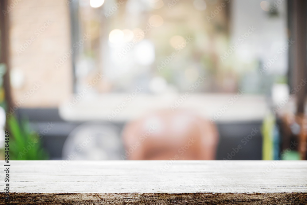 Empty wooden desk space and blurry background of restaurant vintage tone for product display montage. Empty wooden desk space and blurry background of restaurant vintage tone for product display montage.