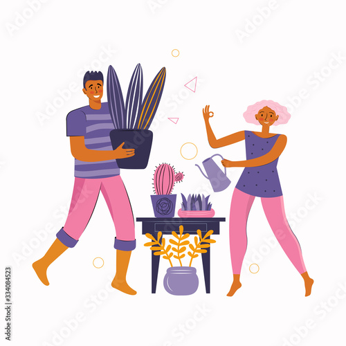 Man and a woman spend time together at home. Young couple take care of home plants together. Stay at home together and do your favorite hobby. Spending time at home. Happy family spends time together