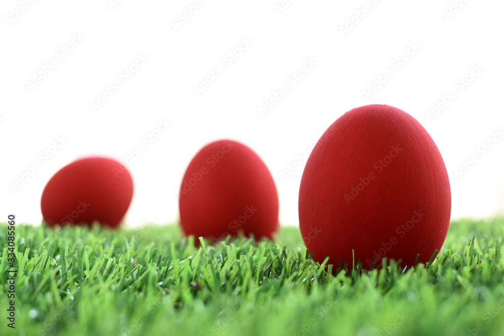 red easter egg on lawn green grass artificial with blank white background