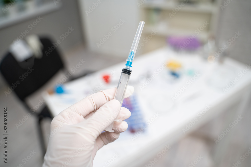 Medic's hand and syringe Medic's hand and syringe