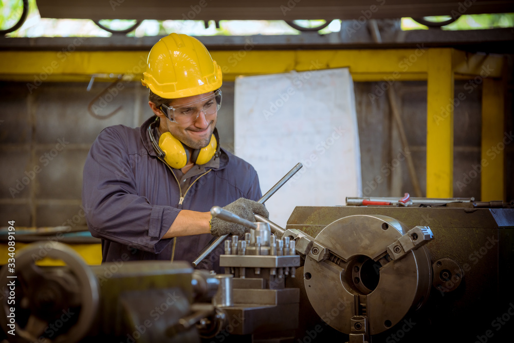 Close up portrait industry engineering wearing safety uniform control operating fixed machine working in industry factory. Close up portrait industry engineering wearing safety uniform control operating fixed machine working in industry factory.