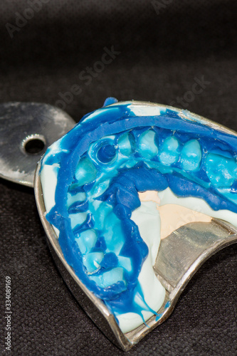 Fototapeta Naklejka Na Ścianę i Meble -  silicone imprint of human teeth close-up. The manufacture of dental crowns and root pins.
