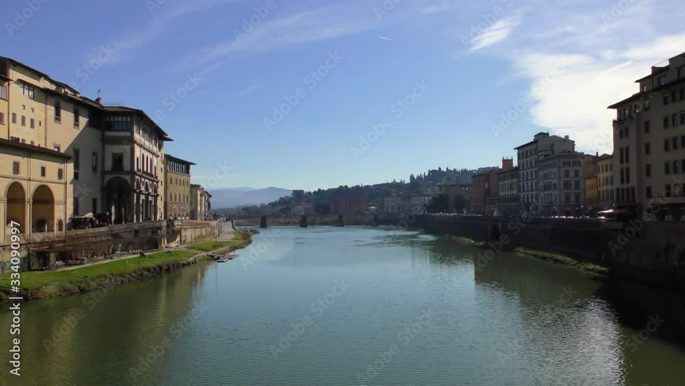 View from the Ponte Vecchio bridge to the Ponte alle Grazie bridge on the Arno River in Florence. View from the Ponte Vecchio bridge to the Ponte alle Grazie bridge on the Arno River in Florence.