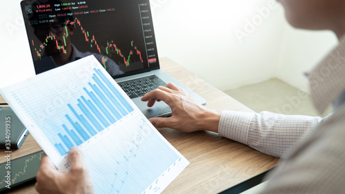 Fotografie Working business man, team of broker or traders talking about forex on multiple computer screens of stock market invest trading financial graph charts data analysis