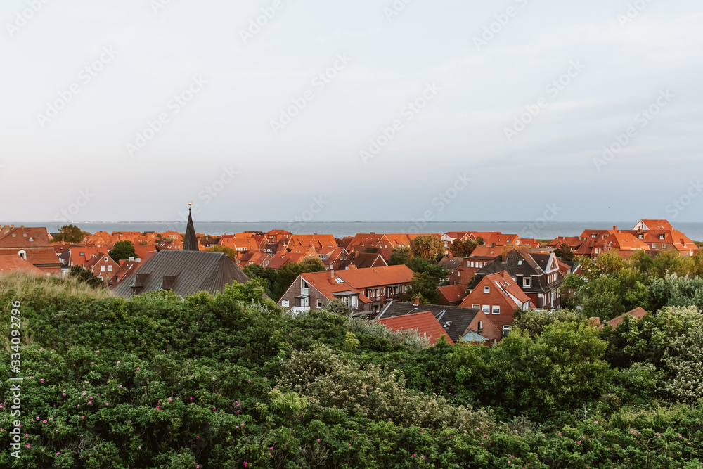 View from the dunes towards the main village on the north sea island Juist, East Frisia, Germany, Europe, in evening light.