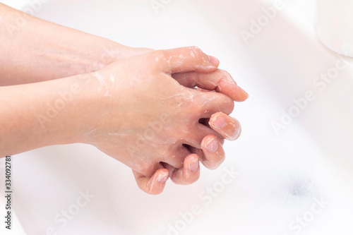 man washes his hands. hands in foam of antibacterial soap. Protection against bacteria, coronaviruses. hand hygiene. wash hands with water.
