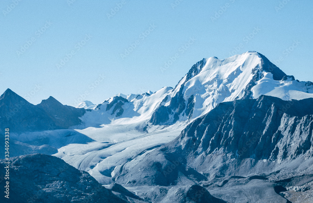 Mountain top view panorama. Lovely scenery landscape with blue sky, snow peaks, high rocks and glacier.