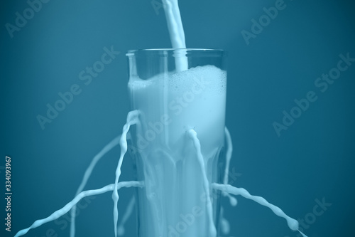 milk is poured into a transparent glass with holes