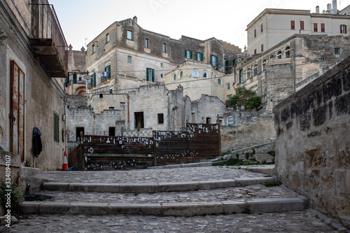 Fototapeta Naklejka Na Ścianę i Meble -  Cobblestone street in the Sassi di Matera a historic district in the city of Matera. Basilicata. Italy