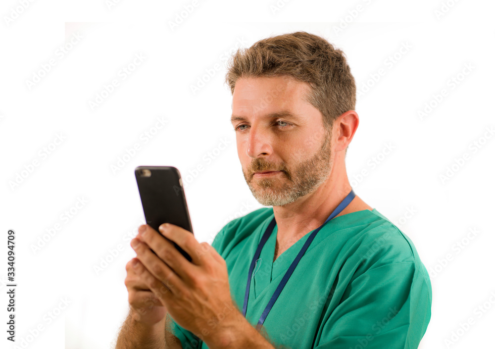 young attractive and successful medicine doctor or nurse man posing confident in green medical uniform using mobile phone smiling standing isolated on white background young attractive and successful medicine doctor or nurse man posing confident in green medical uniform using mobile phone smiling standing isolated on white background