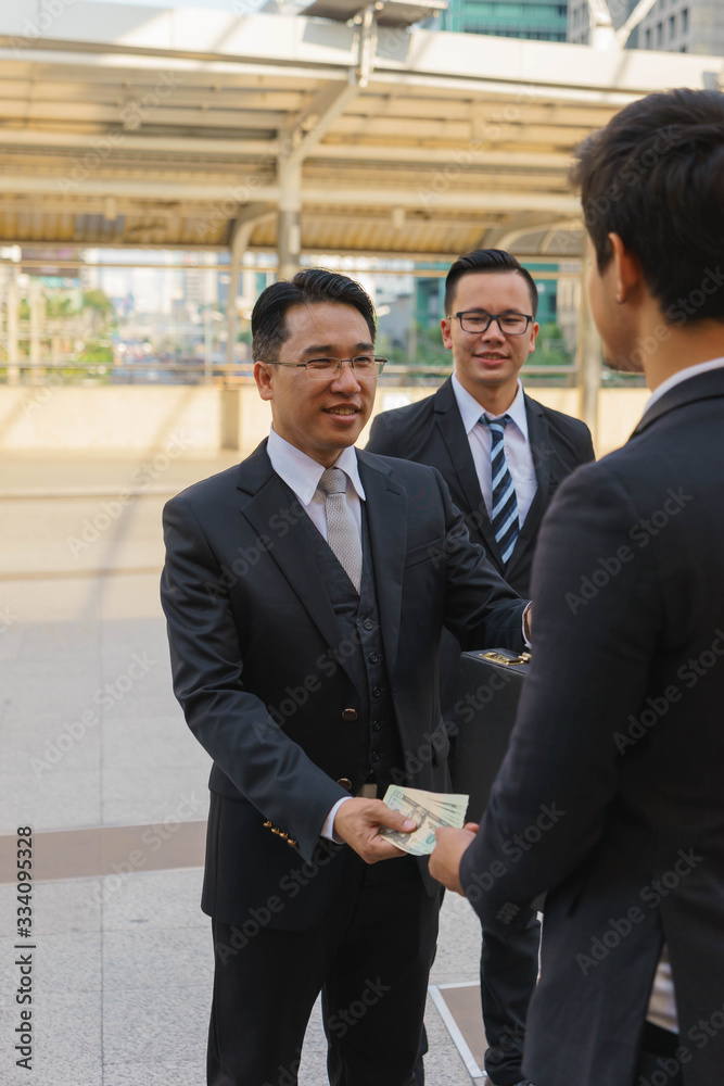 Middle aged boss is handing money exchange for goods. Middle aged boss is handing money exchange for goods.