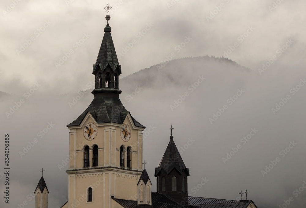 Fototapeta premium Church in Bohinjska Bistrica with cloudy sky
