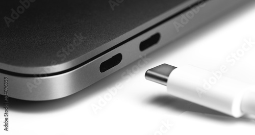 white USB Type-C cable with notebook USB C ports closeup on white table