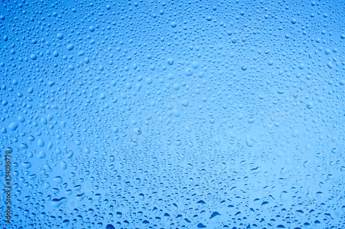Blue water drops on glass. Background.