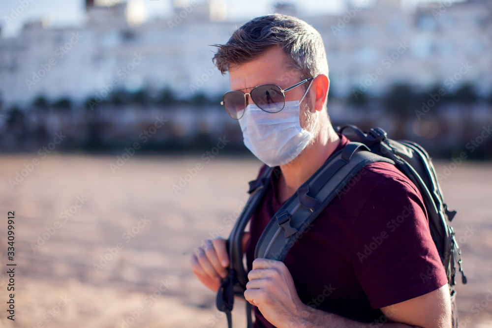Man with medical mask outdoor. People, healthcare and medicine concept