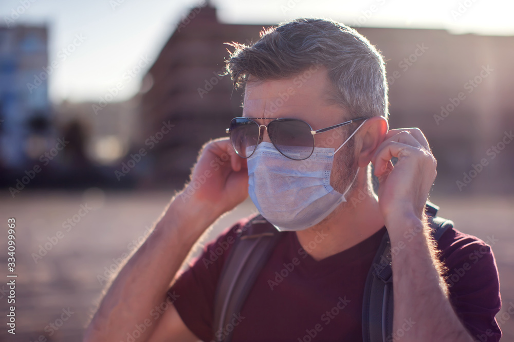 Man with medical mask outdoor. People, healthcare and medicine concept