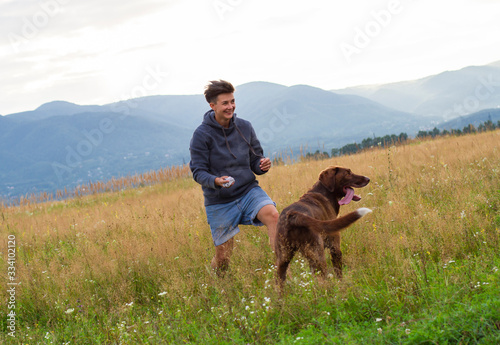 woman with a dog walk on a meadow