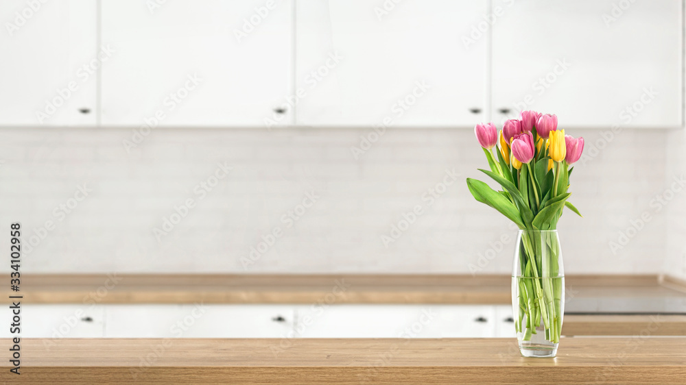 Bouquet of beautiful tulips on the kitchen table top on blur kitchen background with place for montage product display Bouquet of beautiful tulips on the kitchen table top on blur kitchen background with place for montage product display