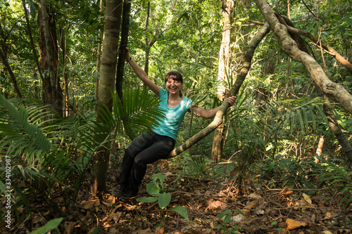 A girl swinging on a liana in the jungle, Koh Chang Island, Thailand