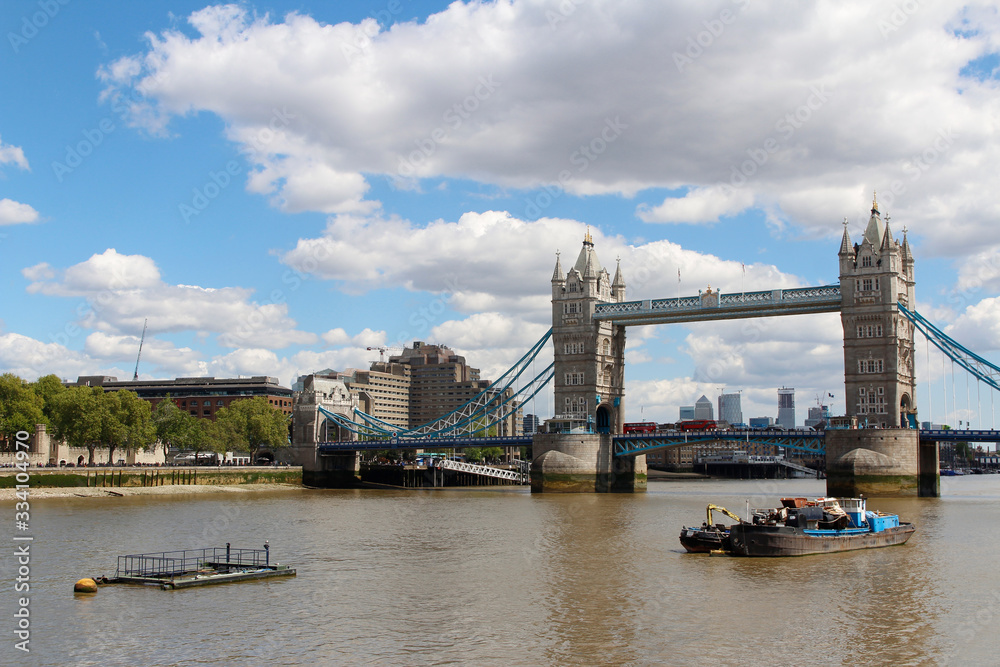 Fototapeta premium Tower Bridge with the blue sky and clouds on a bright sunny day in spring, London, UK