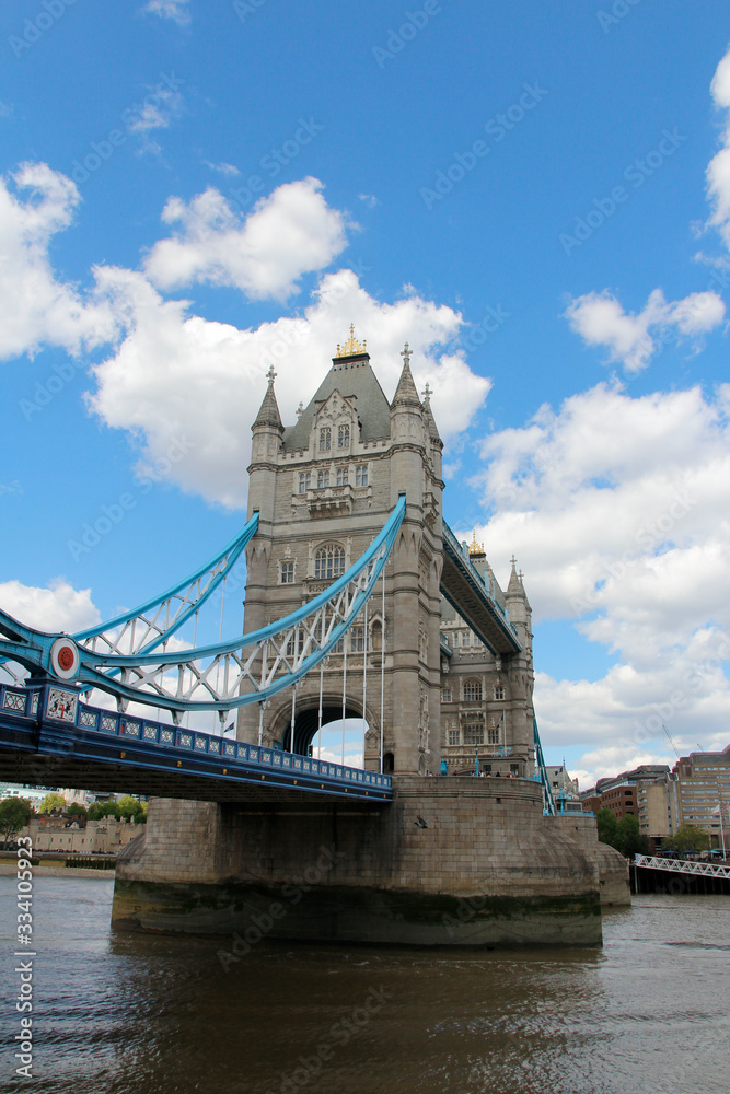 Tower Bridge with the blue sky and clouds on a bright sunny day in spring, London, UK