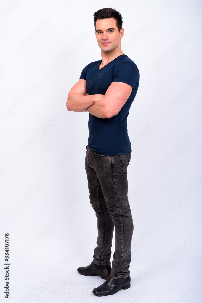 Full body shot of young handsome man with arms crossed Full body shot of young handsome man with arms crossed
