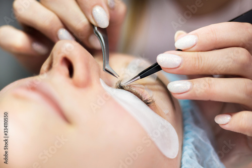 Eyelash Extension Procedure. Woman Eye with Long Eyelashes. Lashes  close up  macro  selective focus.
