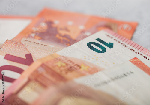 Ten euro banknotes close up on light background.