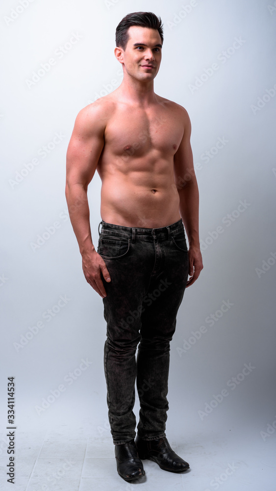 Fototapeta premium Full body shot of young handsome muscular man shirtless