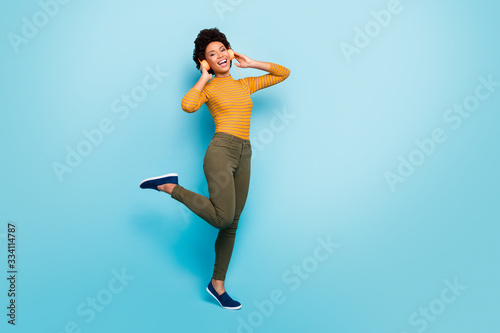 Fototapeta Naklejka Na Ścianę i Meble -  Full length body size view of her she nice attractive girlish cheerful wavy-haired girl listening hit dancing having fun isolated on vivid shine vibrant blue green teal turquoise color background