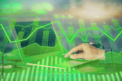 Obraz na płótnie Double exposure of stock market graph with man working on laptop on background