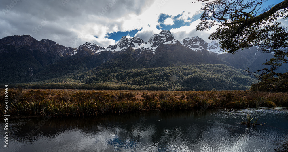Beautiful panorama of Eglinton Mount from Mirror Lakes point on the SH94 road towards Milford Sound with the snow capped mountains in the background taken in spring, New Zealand